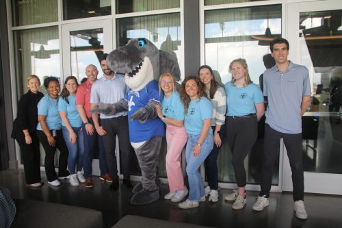a gathering of people with Shark Twain from the St. Louis Aquarium